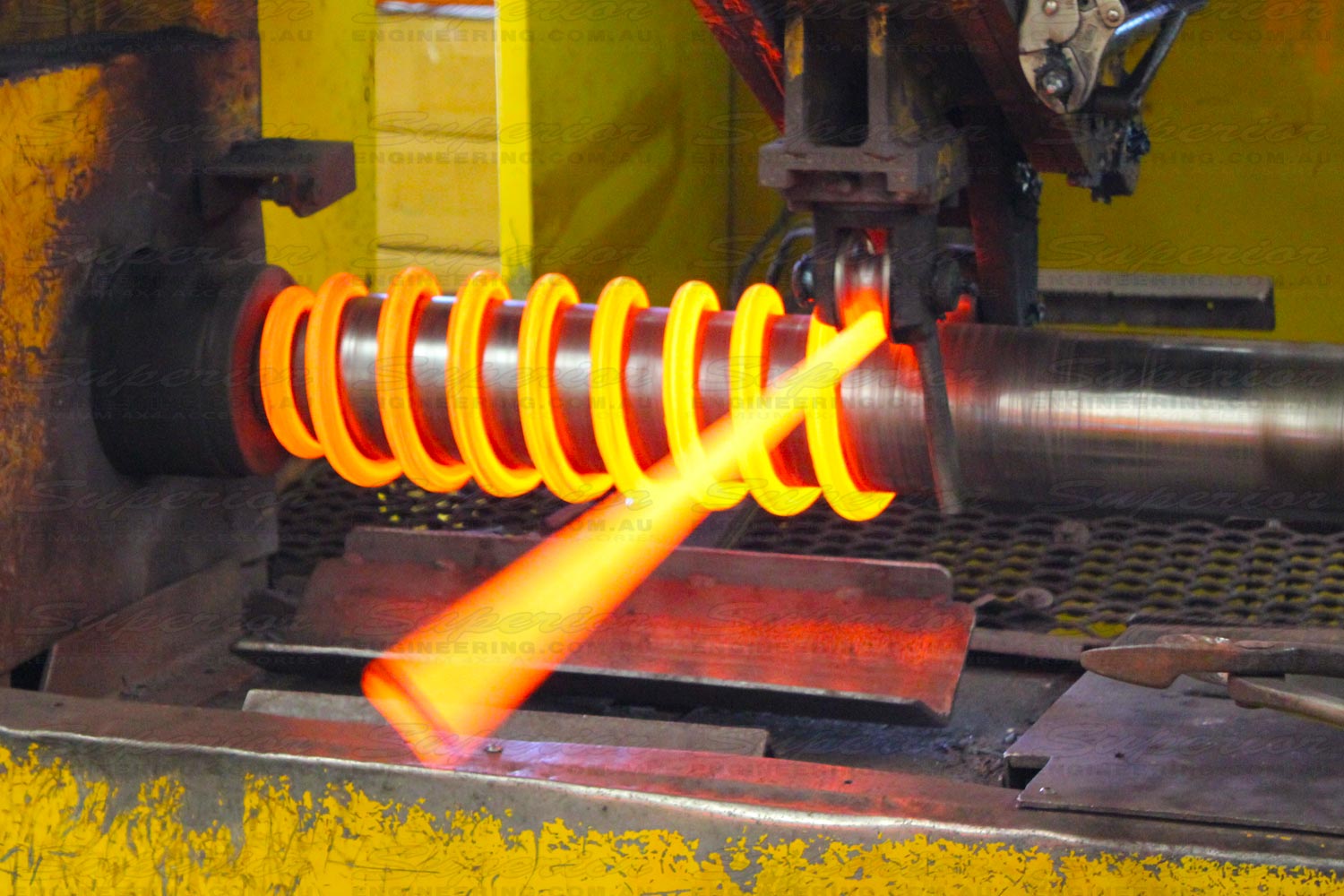 The middle stage of a Superior coil spring being wound and formed on our precision mandrels